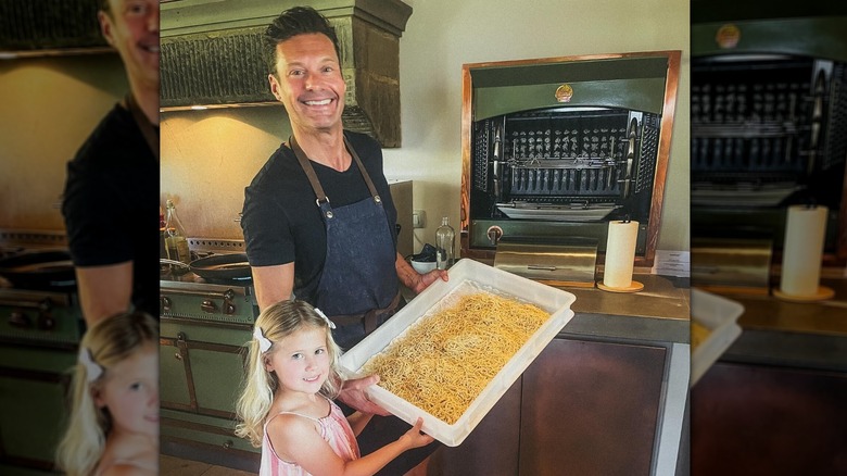 Ryan Seacrest posing with his niece in a kitchen