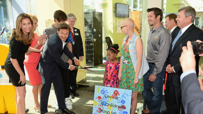 Ryan Seacrest and his family at a ribbon cutting ceremony