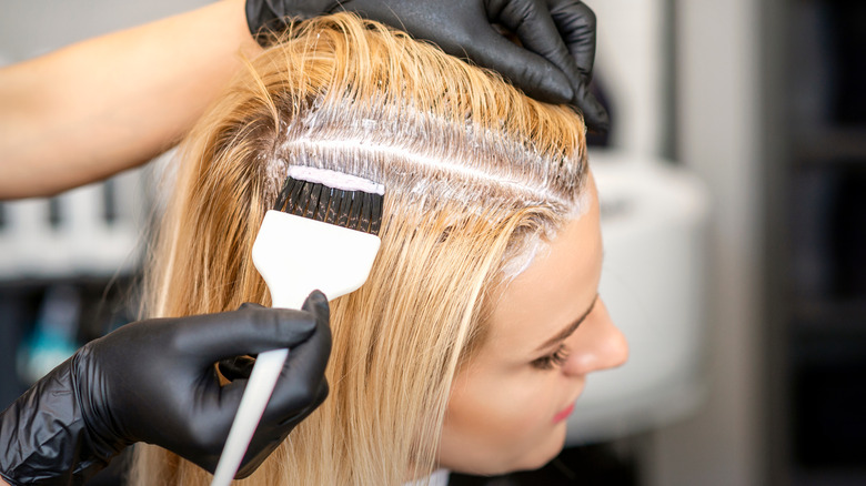 Hot roots being fixed by a hair stylist
