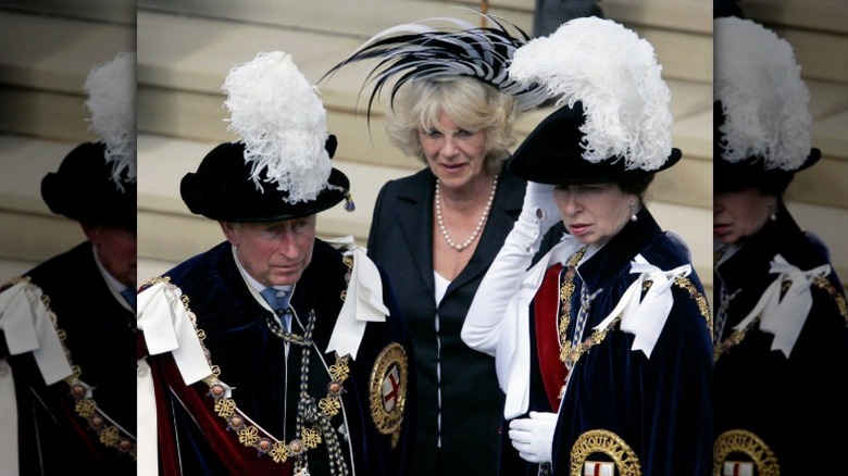 Camilla Parker Bowles standing between Prince Charles and Princess Anne