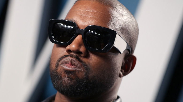 Kanye West in sunglasses, posing