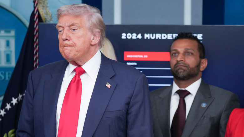Donald Trump in the White House press room with Kash Patel standing behidn him