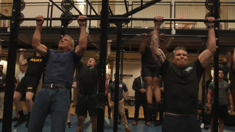 Robert Kennedy Jr. and Pete Hegseth do pull-ups together in August 2025.
