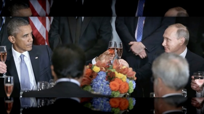 President Barack Obama and Vladimir Putin stare at each other while toasting