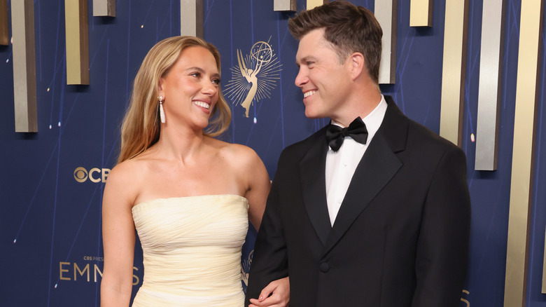 Scarlett Johansson and Colin Jost smiling at each other
