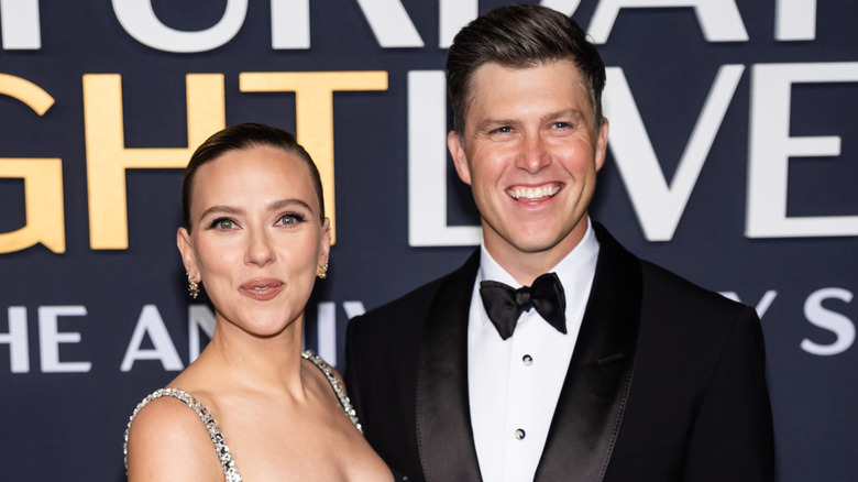 Scarlett Johansson and Colin Jost smiling for the cameras
