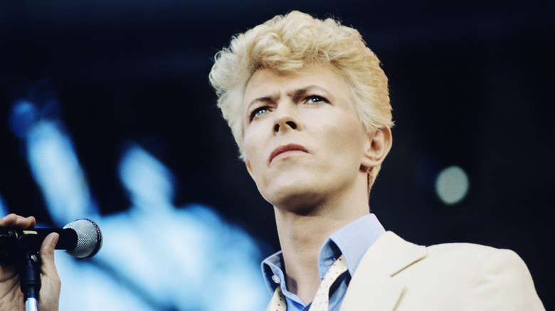 David Bowie staring in front of the microphone