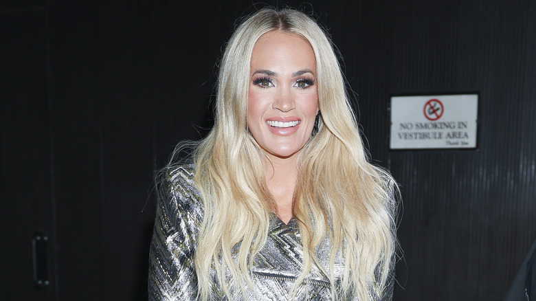Carrie Underwood smiling brightly and posing.