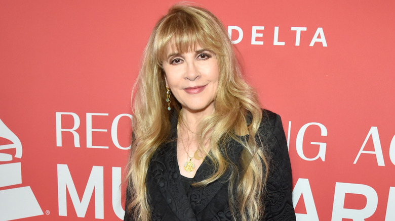 Stevie Nicks smiling and posing at recording academy event.