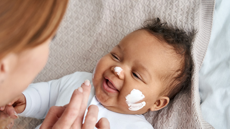 Baby with lotion on face