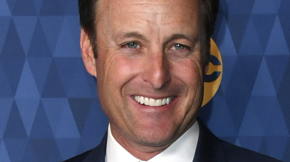 Chris Harrison smiling blue background