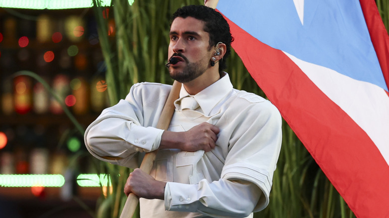 Bad Bunny clutching a pole holding a Puerto Rican flag during the 2026 Super Bowl