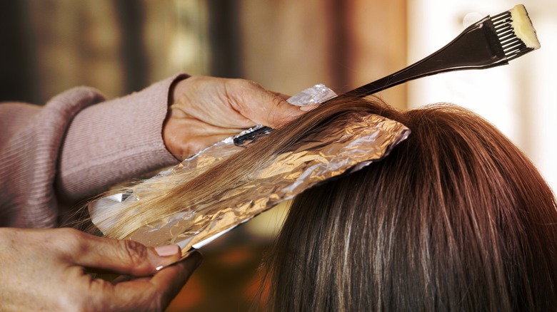 A woman getting her hair dyed 