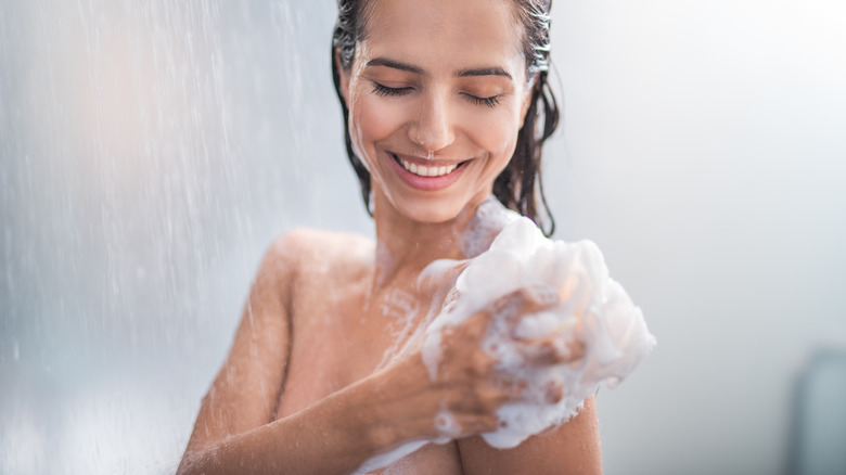woman washing body in shower