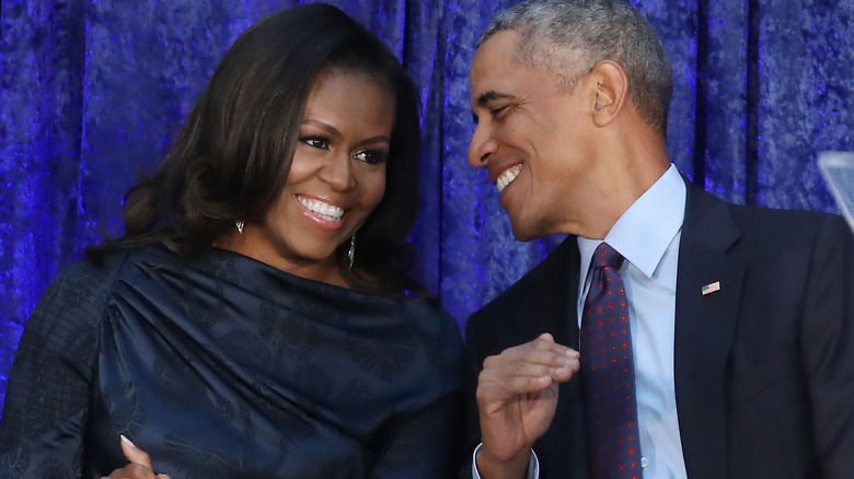 Barack and Michelle Obama smiling together at an event