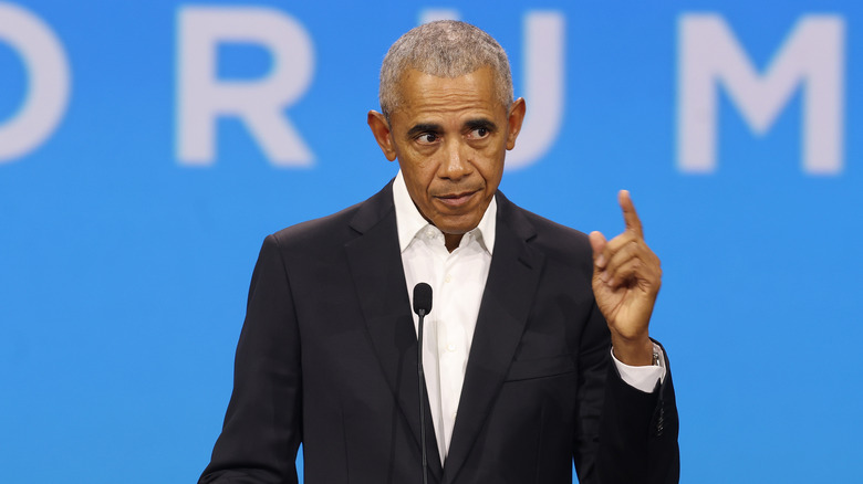 Barack Obama speaking at microphone