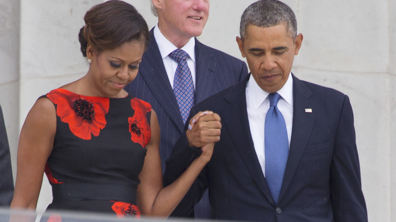 Barack and Michelle Obama holding hands 