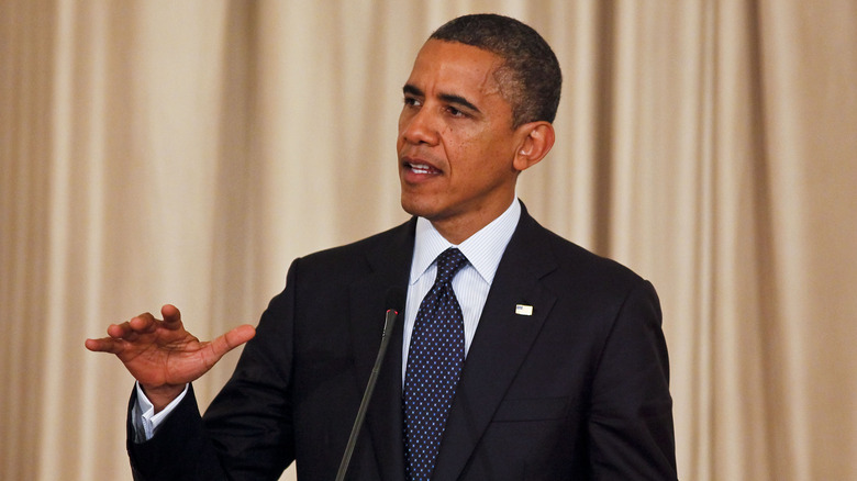Barack Obama speaking into microphone