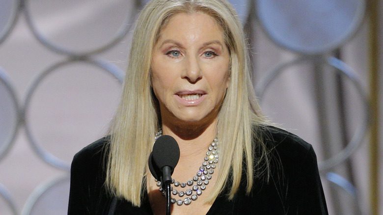 Barbra Streisand speaking into microphone
