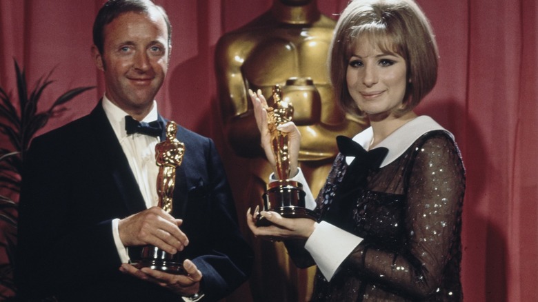 Barbra Streisand and Anthony Harvey holding their Academy Awards