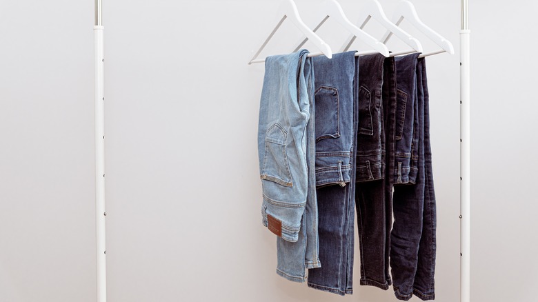 Denim jeans hanging on a rack