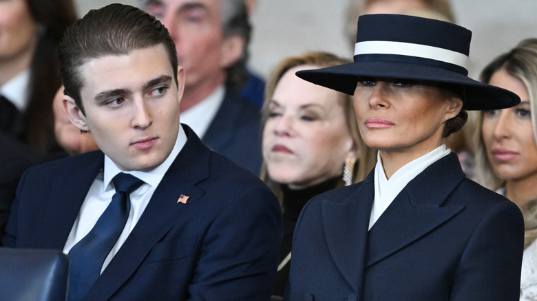 Barron Trump glances to the side while seated beside his mother, Melania Trump, during Donald Trump's 2025 inaugural address.