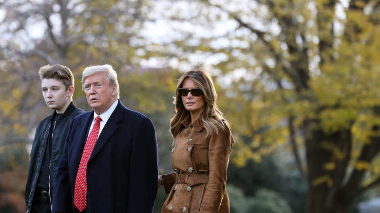 Barron Trump walking with Donald and Melania Trump in 2019 
