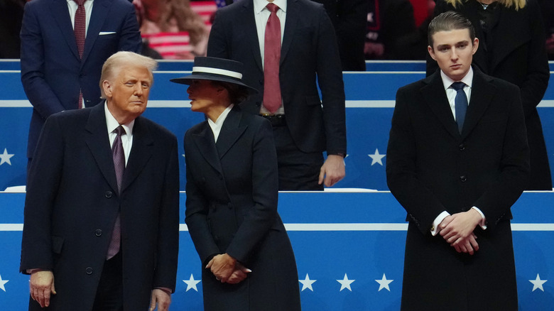 Barron Trump standing beside his mother and father