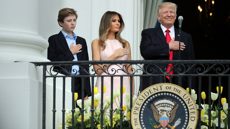 Barron, Melania, and Donald Trump put their hands over their hearts
