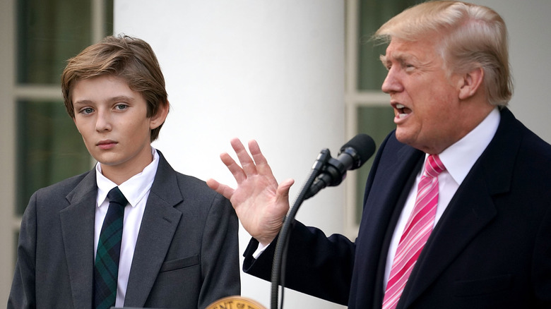 Donald Trump speaking next to Barron Trump
