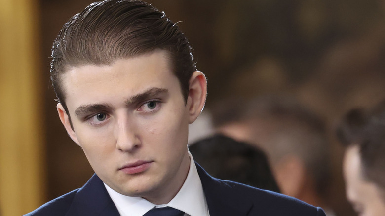 Barron Trump looking serious in a suit