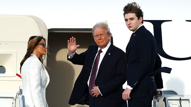 Donald, Melania, and Barron Trump board an airplane