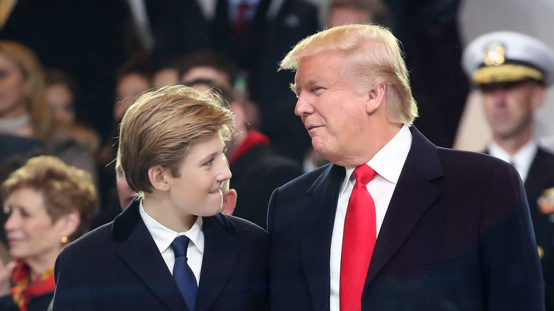 Barron Trump smiles at dad Donald Trump
