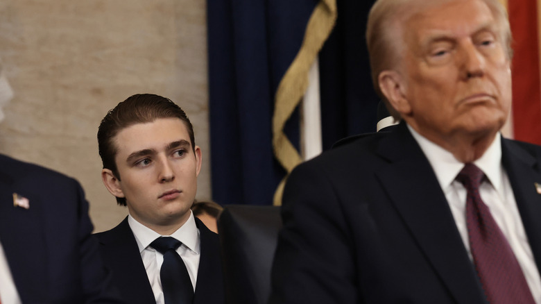 Barron Trump sitting behind Donald Trump