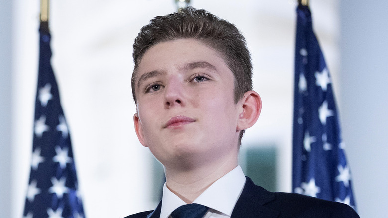 Barron Trump wearing a suit and dark blue tie.