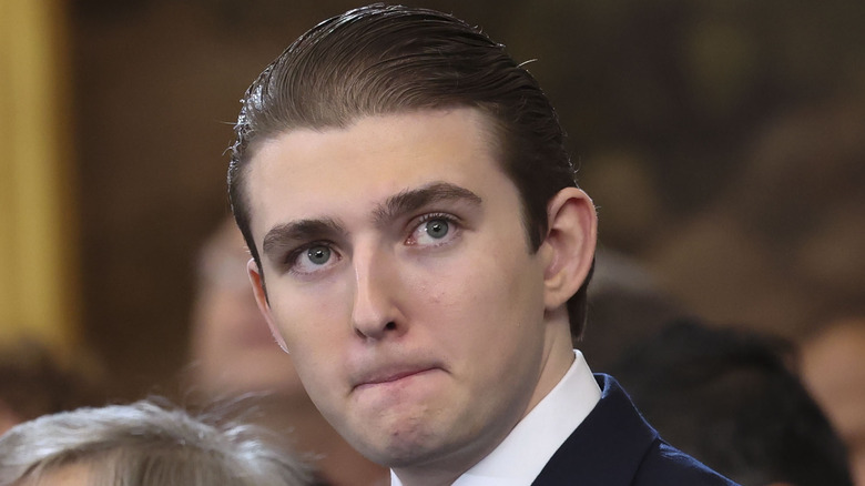 Barron Trump pursing his lips as he looks away