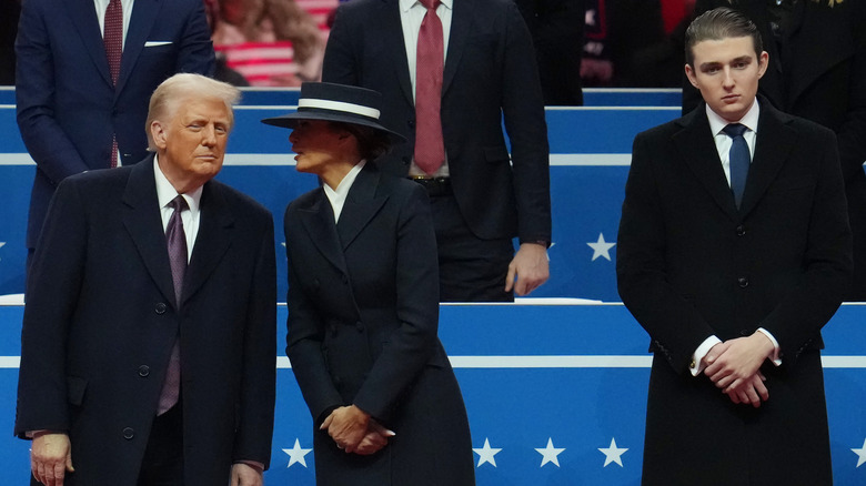 Barron Trump looking annoyed as Melania whispers to Donald Trump