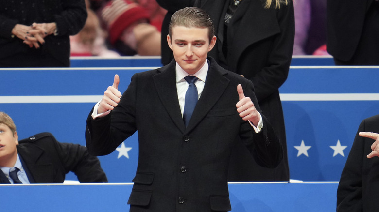 Barron Trump giving a double thumbs up