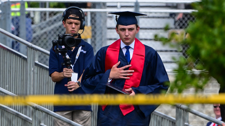 Barron Trump wearing graduation robe