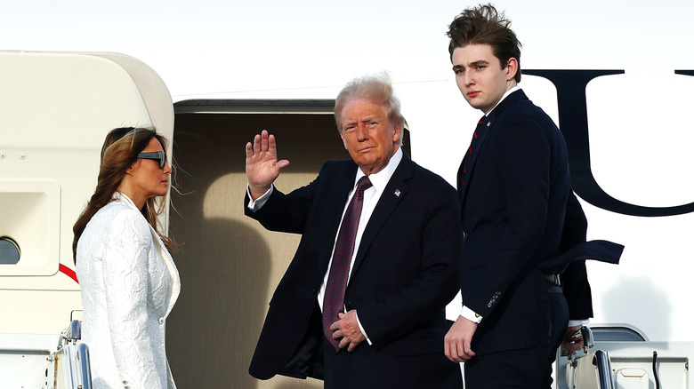 Melania Trump, Donald Trump, and Barron Trump boarding Air Force One with windblown hair