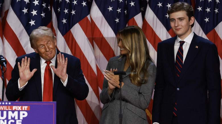 Barron Trump smiling onstage with his parents on election night