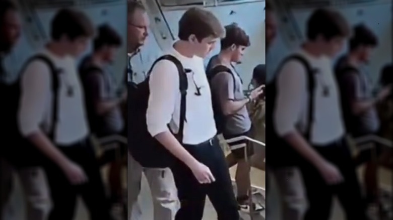 Barron Trump carrying black backpack