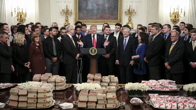 Donald Trump with football team and fast food