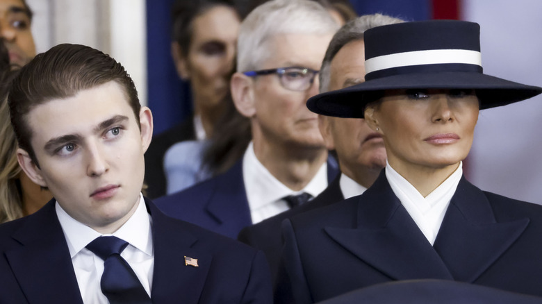 Melania Trump side-eyeing her son Barron while wearing a big hat