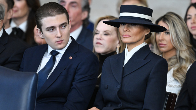 Barron Trump looking at Melania Trump during a funeral