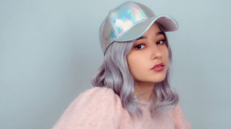 Woman wearing a holographic baseball cap 