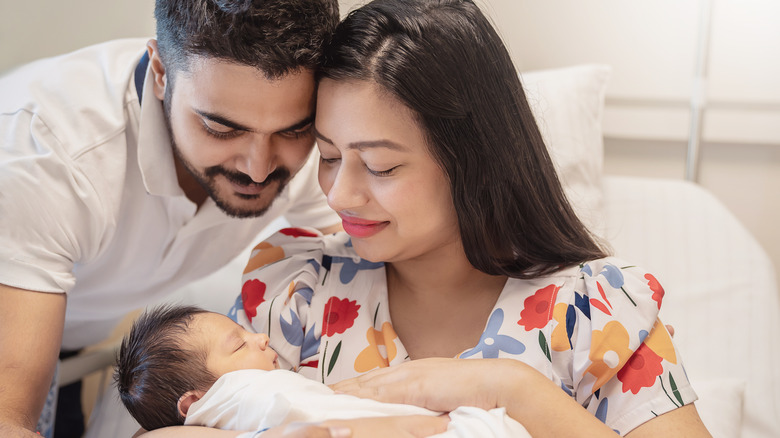 Parents holding sleeping baby