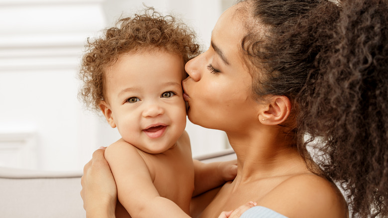 Mother kissing a baby