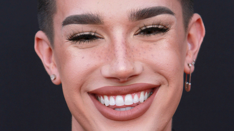 James Charles smiles at a red carpet event