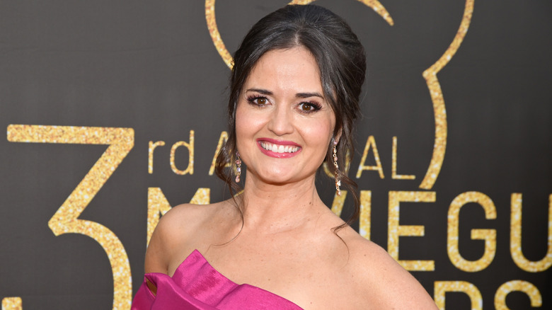 Danica McKellar pink smiling and posing on the red carpet.